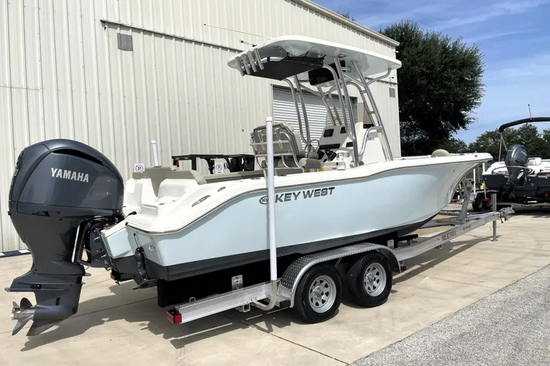 Slide: The Image of 2024 Key West 239 FS boat with Yamaha engine on trailer, parked outdoors. - 3
