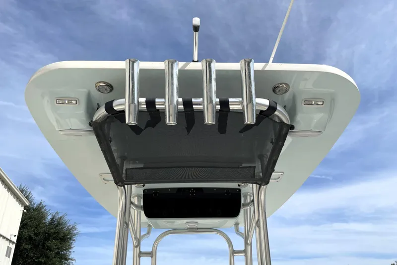Slide: The Image of 2024 Key West 239 FS boat T-top with rod holders against blue sky. - 32