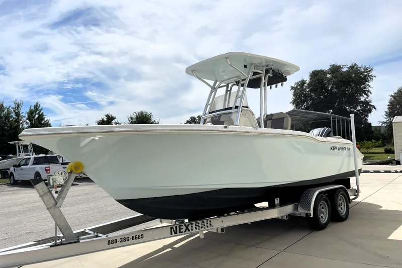 Slide: The Image of 2024 Key West 239 FS boat on trailer under a cloudy sky. - 4