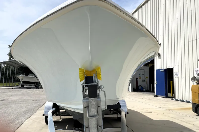 Slide: The Image of 2024 Key West 239 FS boat on trailer outside a large building. - 7