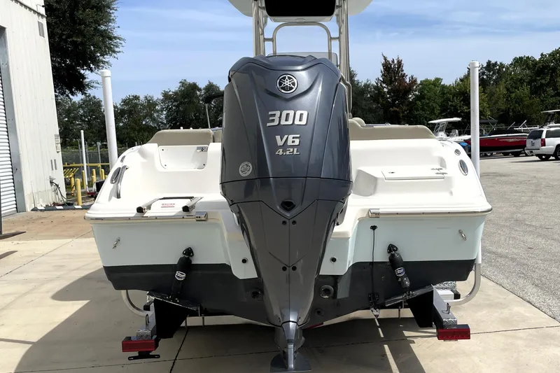 Slide: The Image of 2024 Key West 239 FS boat with Yamaha 300 V6 engine, parked outdoors. - 8