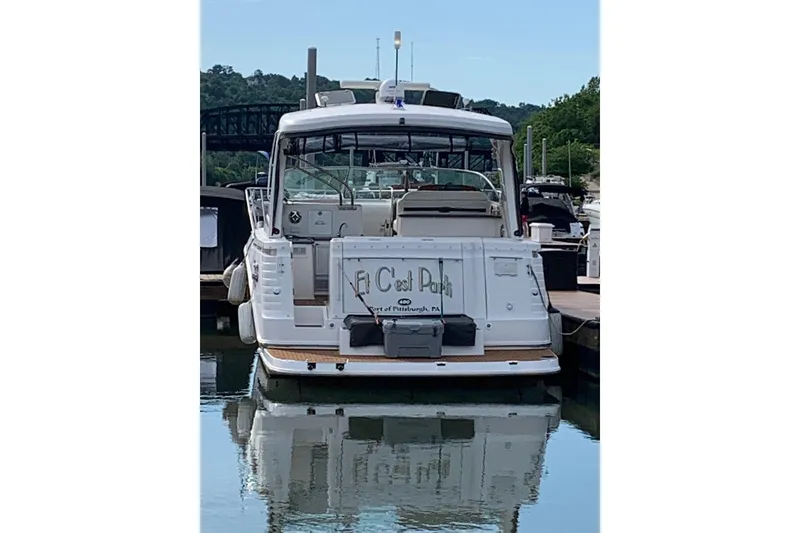 Slide: The Image of 2010 Rinker 400 Express Cruiser docked at a marina, rear view. - 11