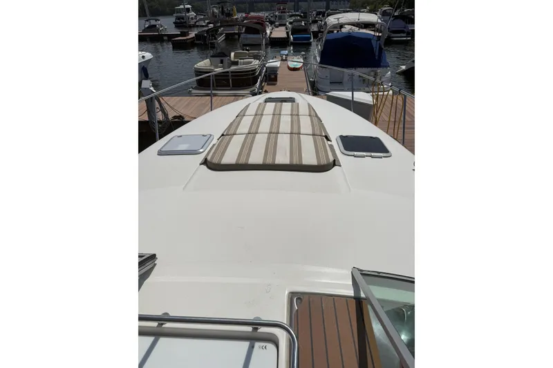 Slide: The Image of 2010 Rinker 400 Express Cruiser docked at marina, view from bow. - 14