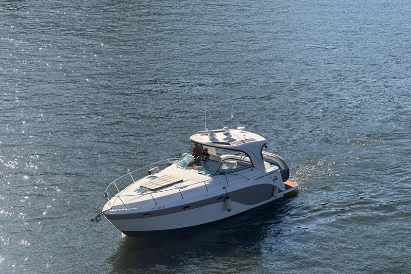 Slide: The Image of 2010 Rinker 400 Express Cruiser on calm water, sunny day. - 16