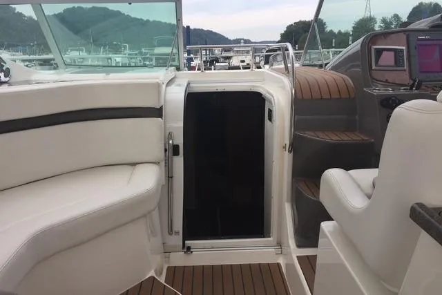 Slide: The Image of 2010 Rinker 400 Express Cruiser cockpit with white seating and wood accents. - 19