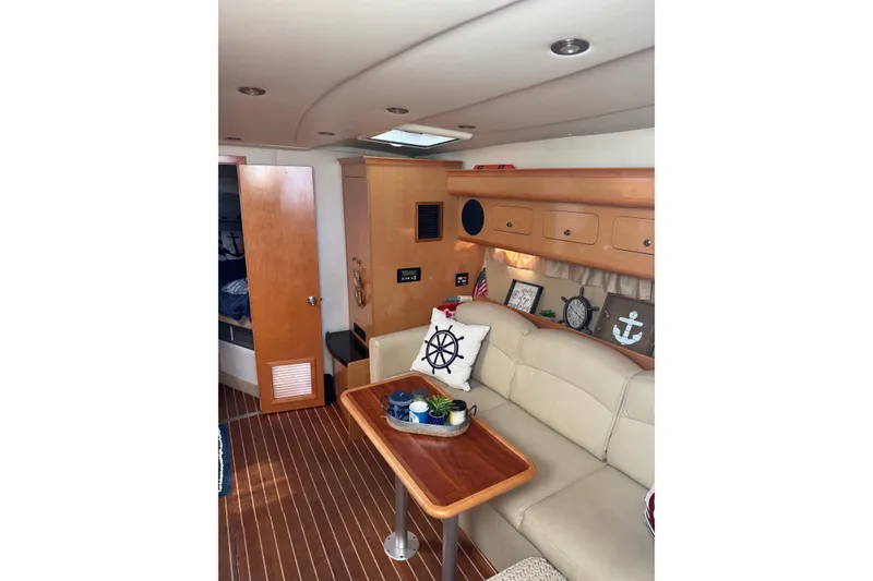 Slide: The Image of Interior of 2010 Rinker 400 Express Cruiser with beige seating and nautical decor. - 25