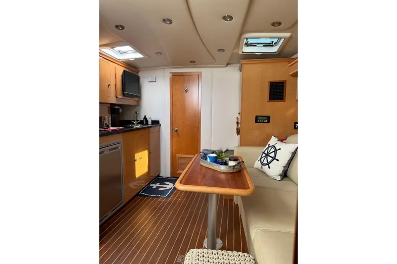 Slide: The Image of Interior of 2010 Rinker 400 Express Cruiser with cozy seating and modern amenities. - 26
