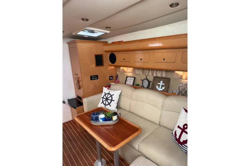 Slide: The Image of Interior of 2010 Rinker 400 Express Cruiser with nautical-themed decor and wooden cabinetry. - 27
