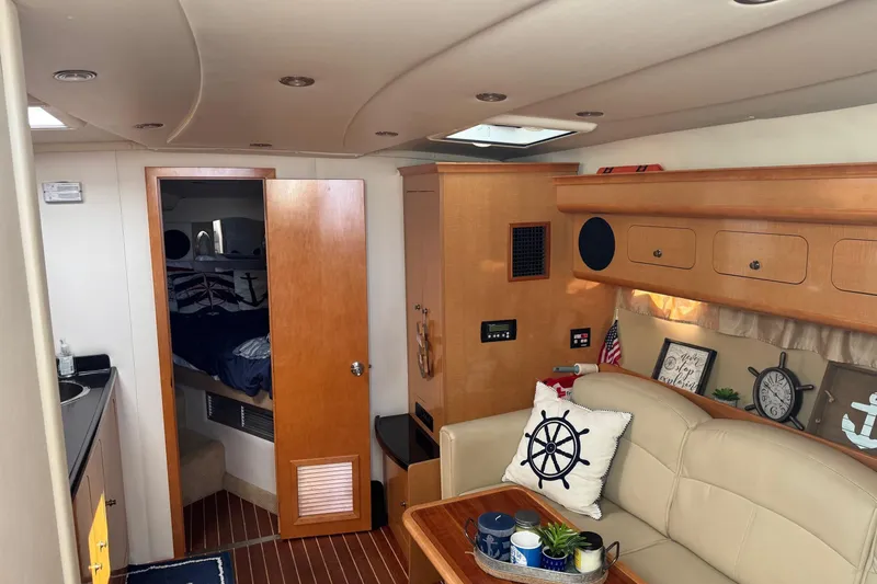 Slide: The Image of Interior of 2010 Rinker 400 Express Cruiser with cozy seating and nautical decor. - 30