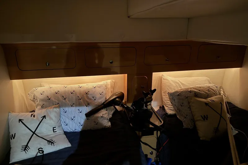Slide: The Image of Cozy cabin interior of 2010 Rinker 400 Express Cruiser with nautical-themed pillows. - 34