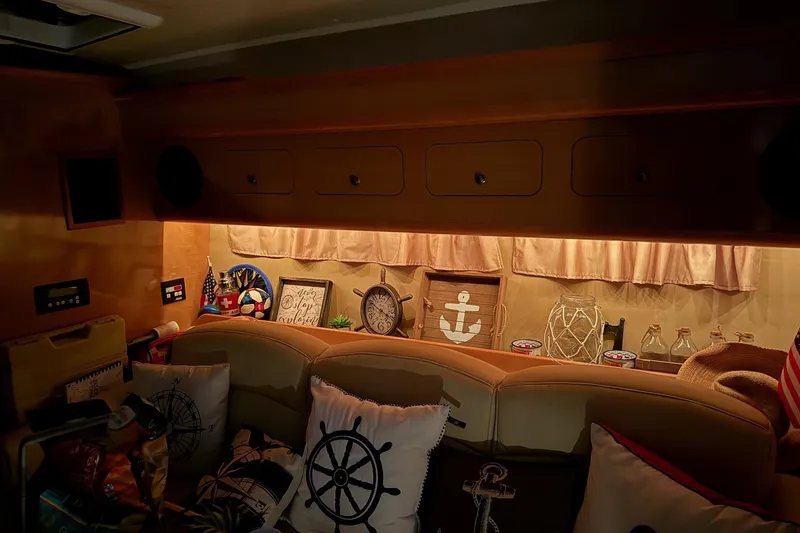 Slide: The Image of Interior of 2010 Rinker 400 Express Cruiser with nautical decor and cozy seating. - 35