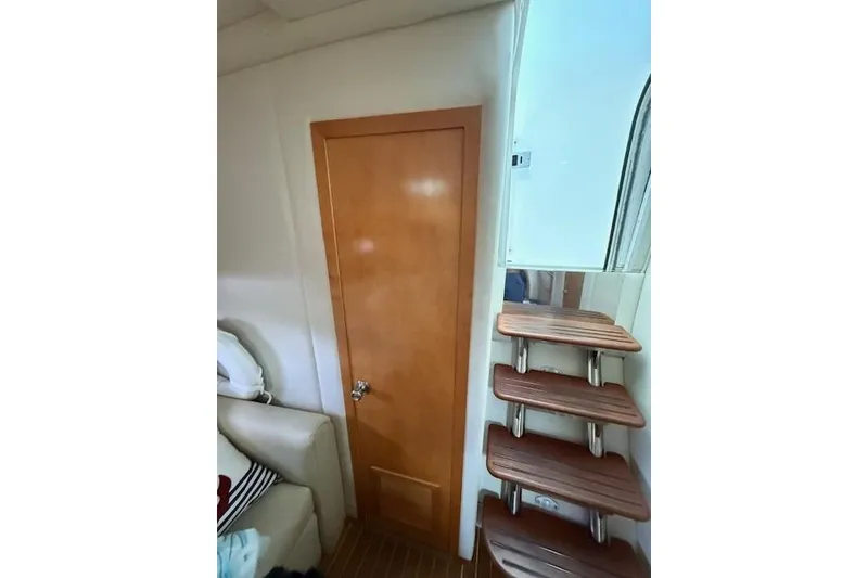 Slide: The Image of Interior of 2010 Rinker 400 Express Cruiser with wooden door and stairs. - 39