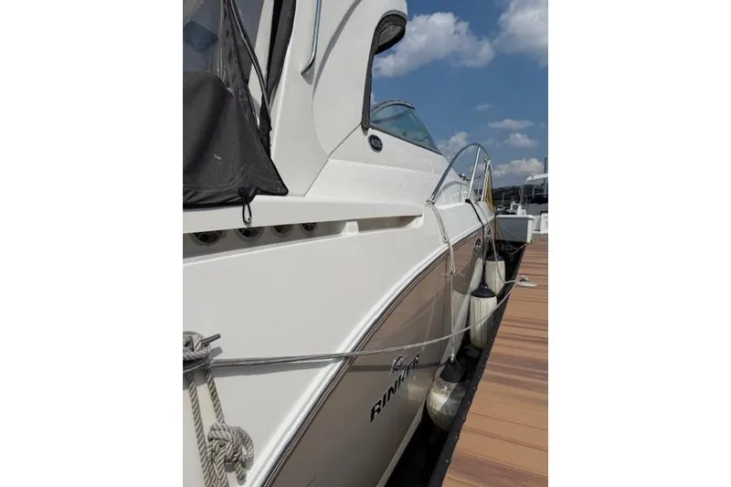 Slide: The Image of 2010 Rinker 400 Express Cruiser docked under a clear blue sky. - 8