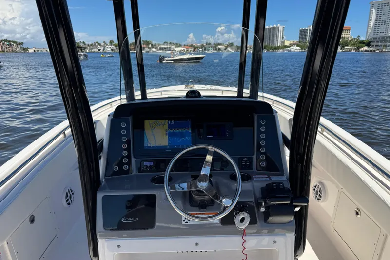 Slide: The Image of 2022 Robalo R242 Center Console boat dashboard with navigation display on a sunny day. - 13