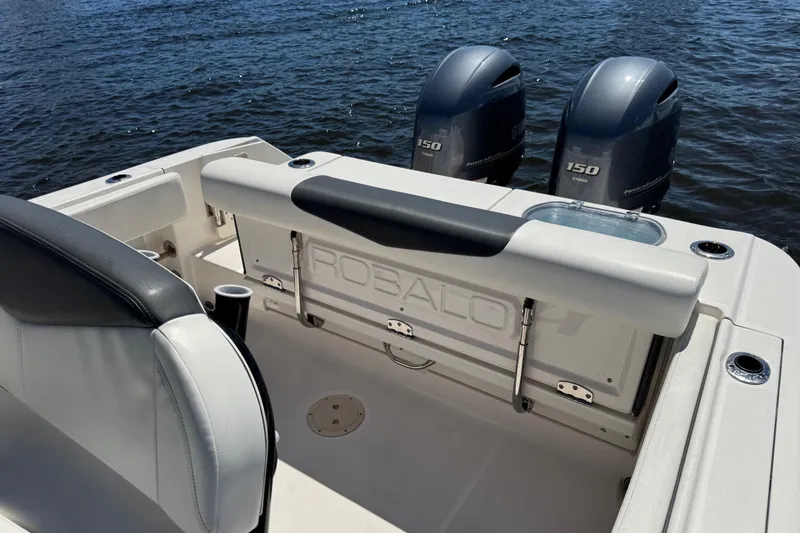 Slide: The Image of 2022 Robalo R242 Center Console boat with dual Yamaha 150 engines on water. - 18