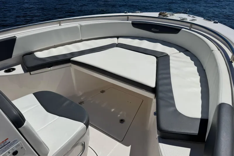 Slide: The Image of 2022 Robalo R242 Center Console boat docked by a serene riverbank. - 7
