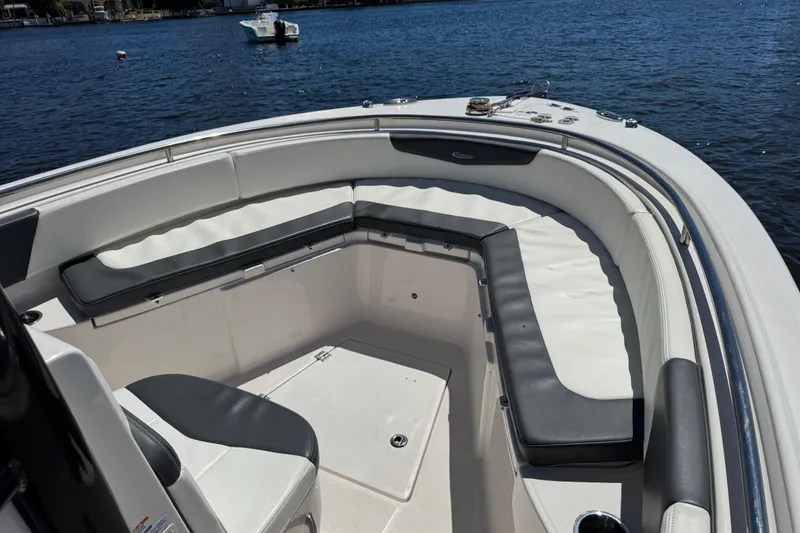 Slide: The Image of 2022 Robalo R242 Center Console boat docked near lush greenery. - 8