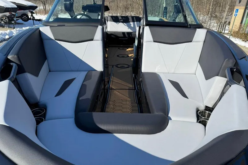 Slide: The Image of 2025 MasterCraft NXT23 boat interior with modern seating and cup holders. - 10