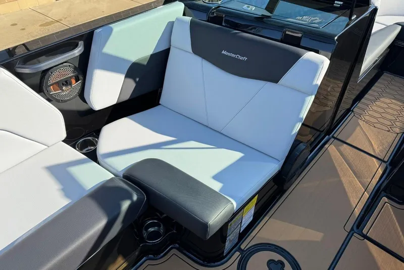Slide: The Image of 2025 MasterCraft NXT23 boat interior with sleek seating and modern design. - 6