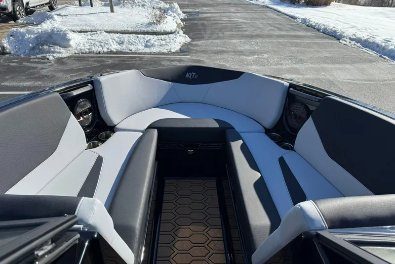 Slide: The Image of 2025 MasterCraft NXT23 boat interior with sleek seating and modern design. - 8