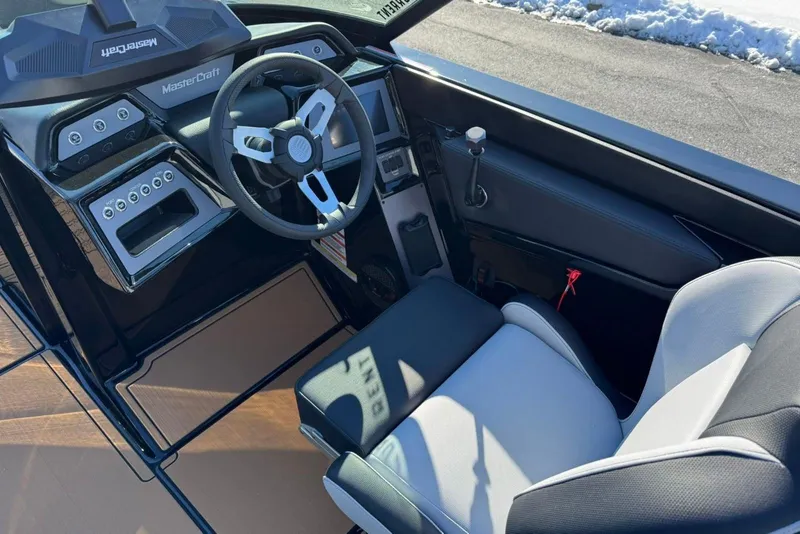 Slide: The Image of 2025 MasterCraft NXT23 boat interior with modern steering and control panel. - 9