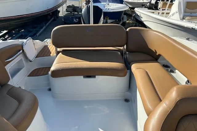 Slide: The Image of 2023 Crownline 250 XSS boat interior with tan seating and white deck. - 10