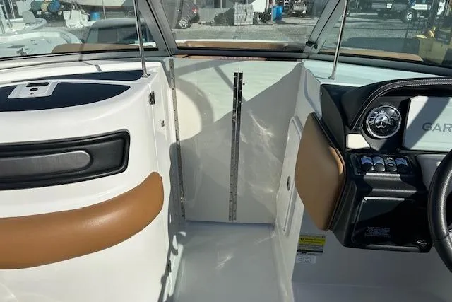 Slide: The Image of 2023 Crownline 250 XSS boat interior with modern dashboard and seating. - 11