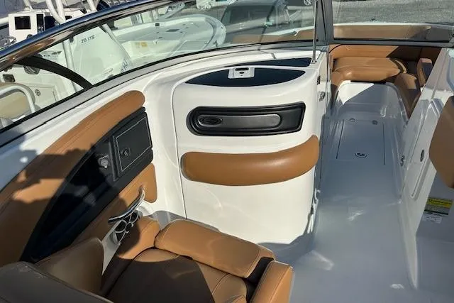 Slide: The Image of 2023 Crownline 250 XSS boat interior with tan leather seating and sleek design. - 13