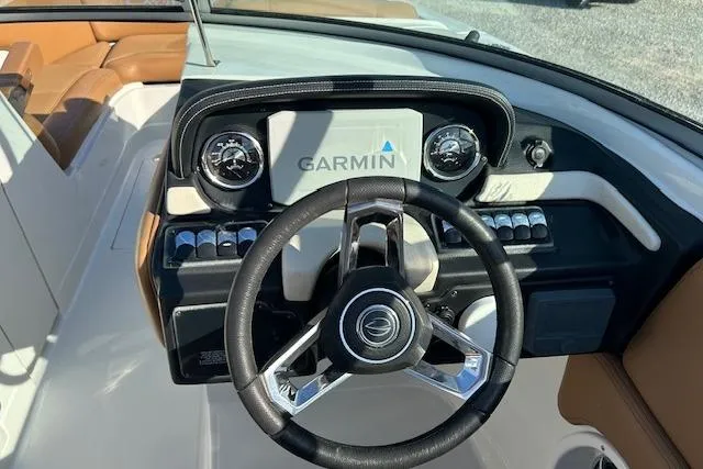 Slide: The Image of 2023 Crownline 250 XSS boat dashboard with Garmin navigation system and steering wheel. - 14