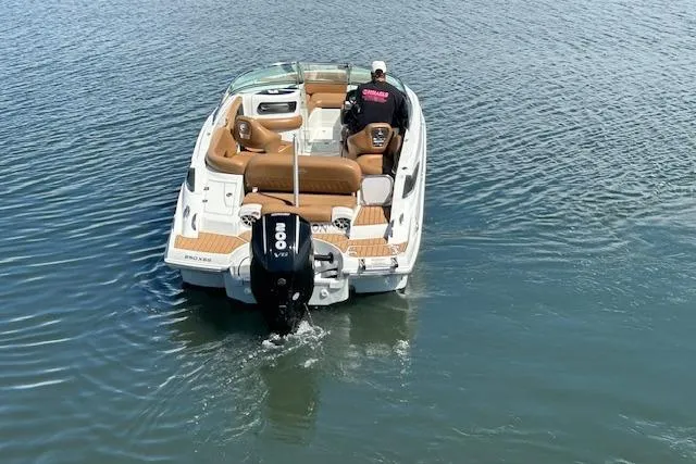 Slide: The Image of 2023 Crownline 250 XSS boat on water, featuring a powerful outboard motor. - 3
