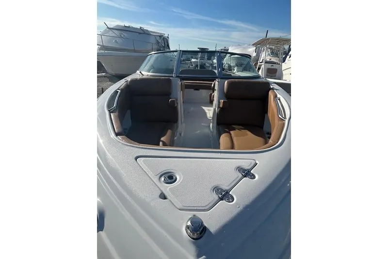 Slide: The Image of 2023 Crownline 250 XSS boat with spacious seating and sleek design. - 7