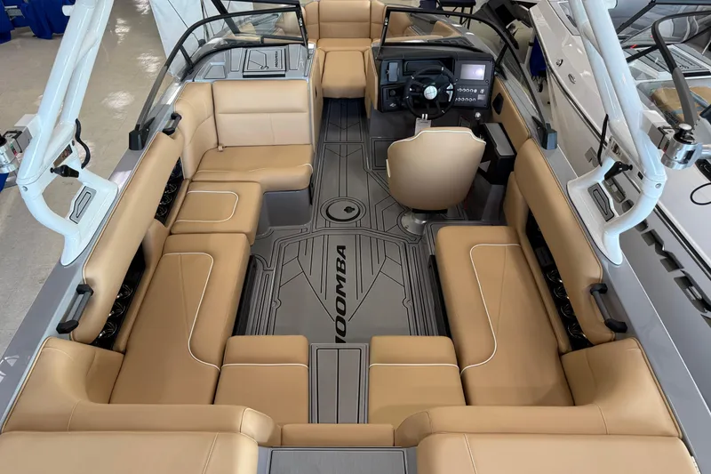 Slide: The Image of 2026 Moomba Craz boat interior with tan seating and modern dashboard design. - 14
