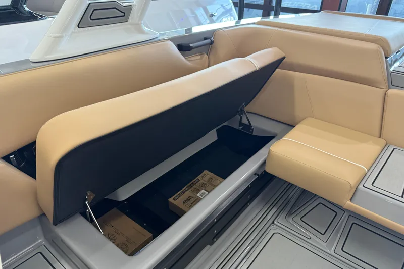 Slide: The Image of 2026 Moomba Craz boat interior with open storage compartment under tan seating. - 20
