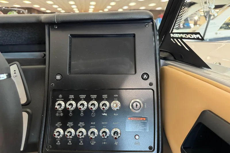 Slide: The Image of 2026 Moomba Craz boat dashboard with control panel and switches. - 24