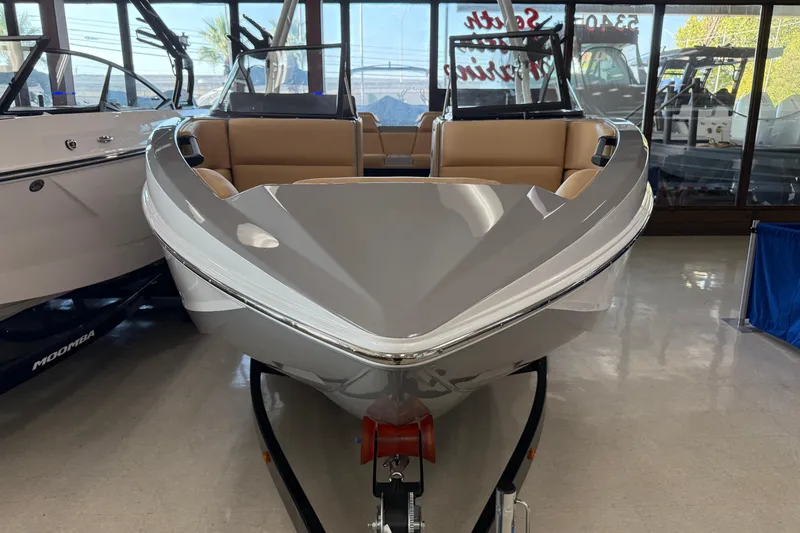 Slide: The Image of 2026 Moomba Craz boat in showroom, front view with sleek design and tan seating. - 3