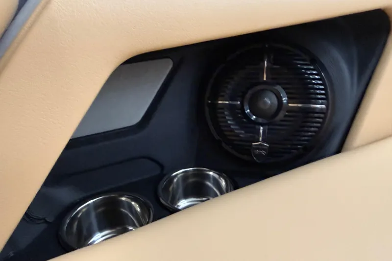 Slide: The Image of 2026 Moomba Craz interior speaker and cup holders in beige upholstery. - 35