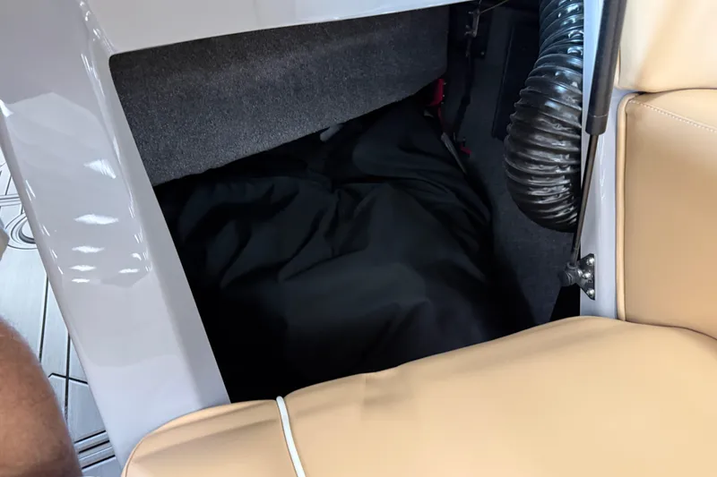 Slide: The Image of Interior storage compartment of 2026 Moomba Craz boat with beige seating. - 38