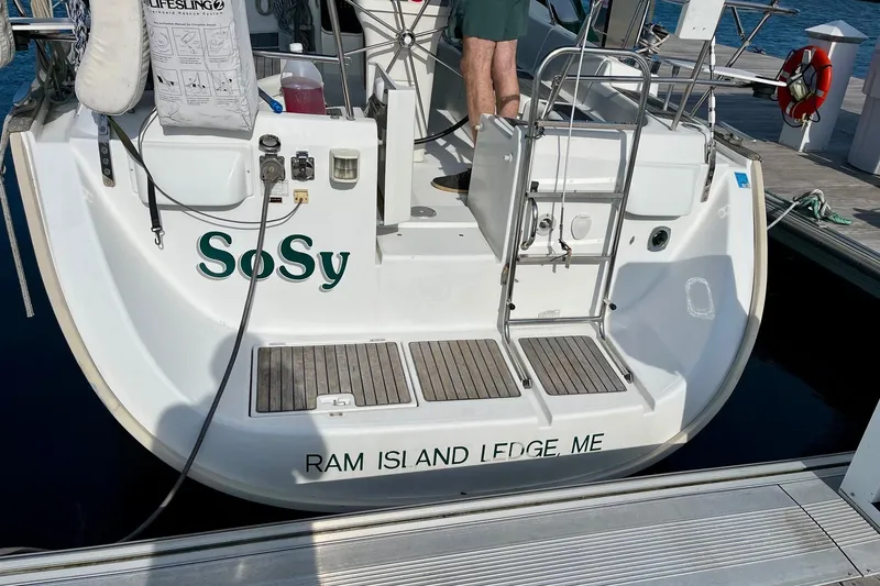The Image of 2006 Beneteau Oceanis Clipper 423 docked, showing stern with "SoSy" and "Ram Island Ledge, ME." - 0