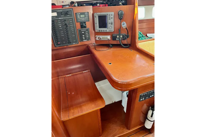 Slide: The Image of Control panel of a 2006 Beneteau Oceanis Clipper 423 sailboat with navigation and communication equipment. - 14