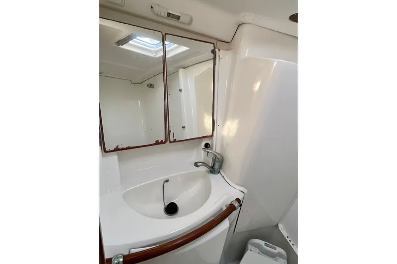Slide: The Image of Bathroom interior of 2006 Beneteau Oceanis Clipper 423 yacht, featuring compact toilet and sink. - 25
