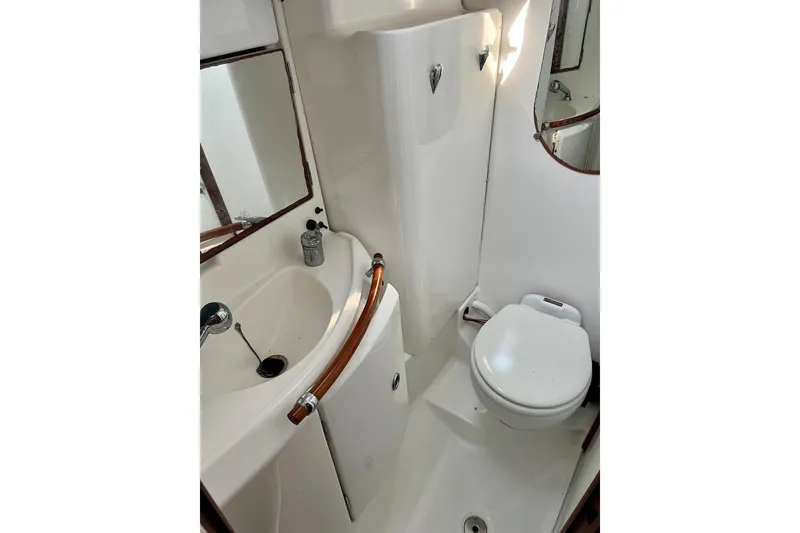 Slide: The Image of White sink with chrome faucet and plug chain, aboard 2006 Beneteau Oceanis Clipper 423 yacht. - 27