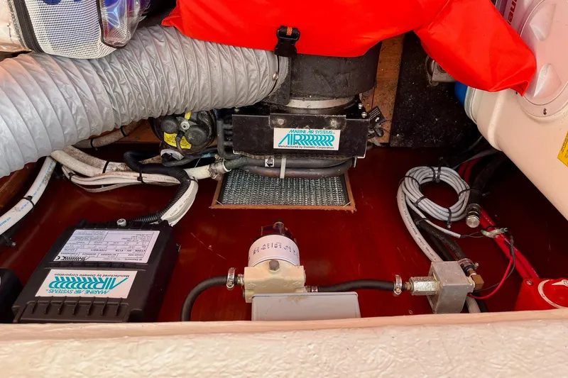 Slide: The Image of Engine compartment of 2006 Beneteau Oceanis Clipper 423 with hoses and maintenance supplies. - 31