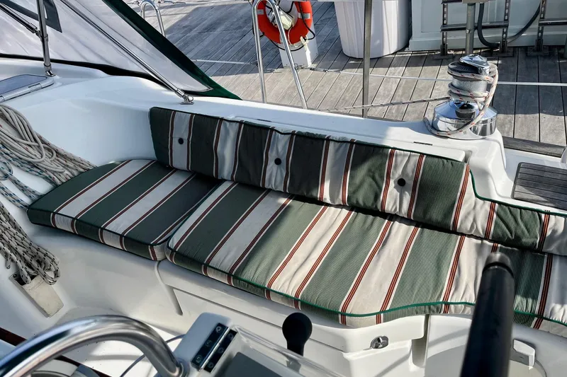 Slide: The Image of 2006 Beneteau Oceanis Clipper 423 cockpit with striped cushions and nautical equipment. - 4