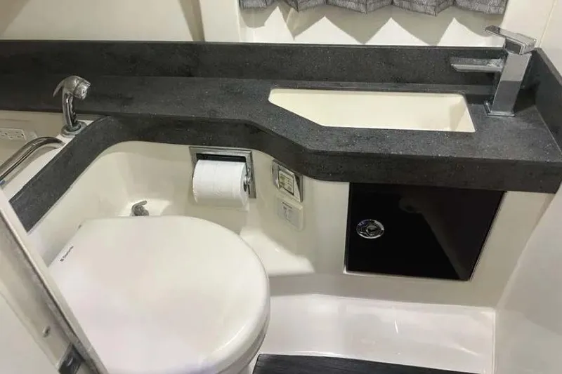 Slide: The Image of 2015 Formula 350 Crossover Bowrider bathroom with modern sink and toilet. - 6
