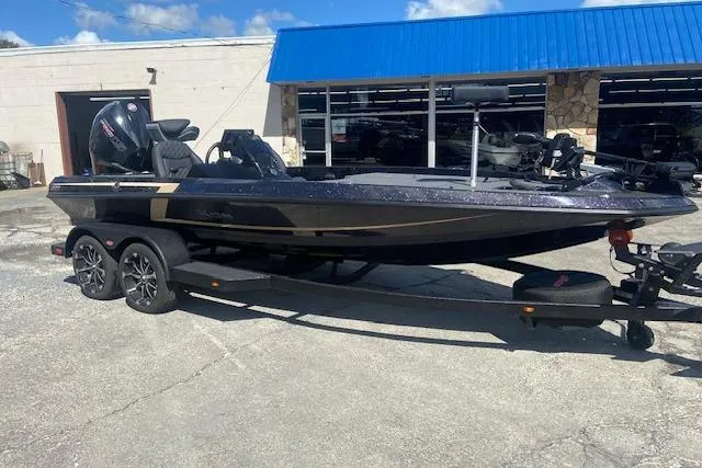 The Image of 2026 iKon VLX 20 boat on trailer, parked outside a building with blue awning. - 1
