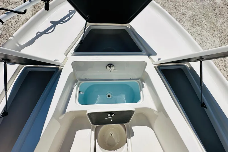 Slide: The Image of 2026 Key West 230 Bay Reef boat storage compartments and livewell. - 14