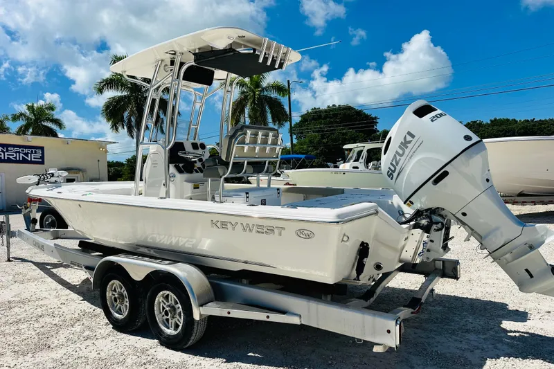 Slide: The Image of 2026 Key West 230 Bay Reef boat with Suzuki engine on trailer, sunny day. - 5