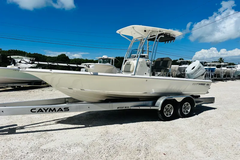 Slide: The Image of 2026 Key West 230 Bay Reef boat on a Caymas trailer, parked outdoors. - 7