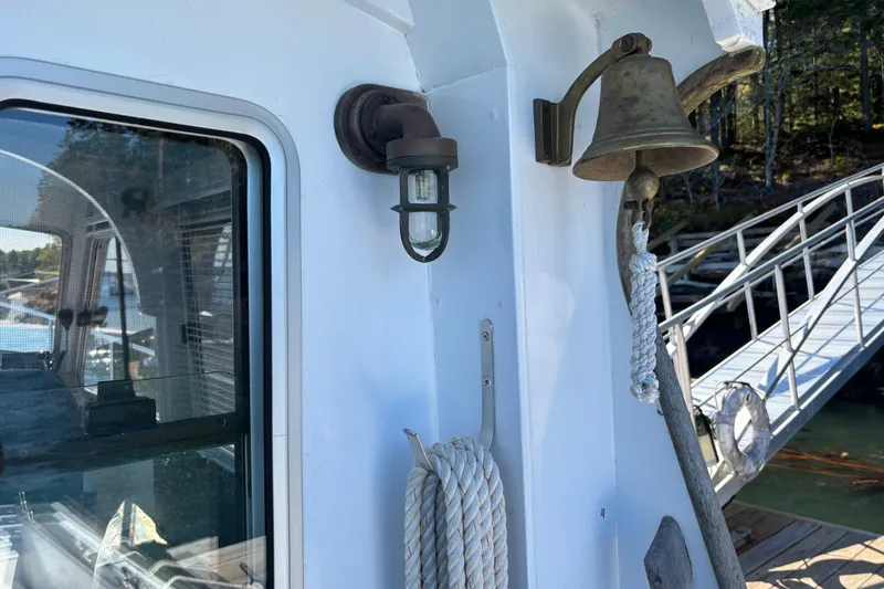 Slide: The Image of 1985 Jarvis Newman 36 boat detail with bell, light, and dock view. - 13