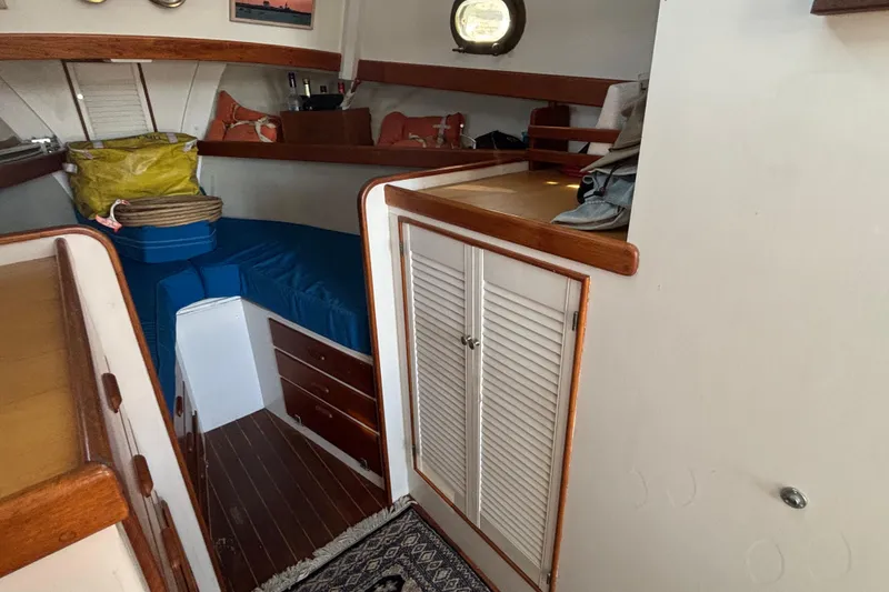 Slide: The Image of Interior of 1985 Jarvis Newman 36 boat with wooden cabinetry and blue cushions. - 29